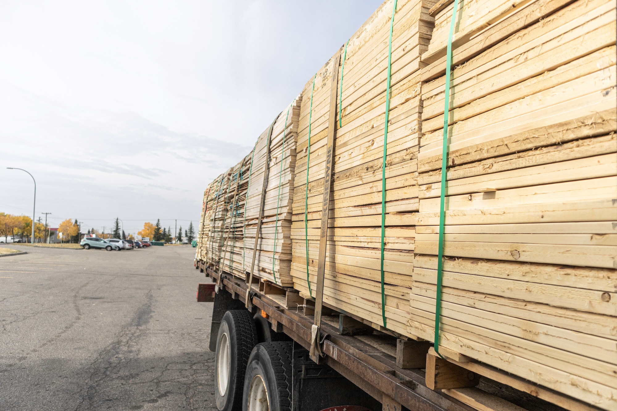 Flat-bed semi-truck carrying shipments of timber