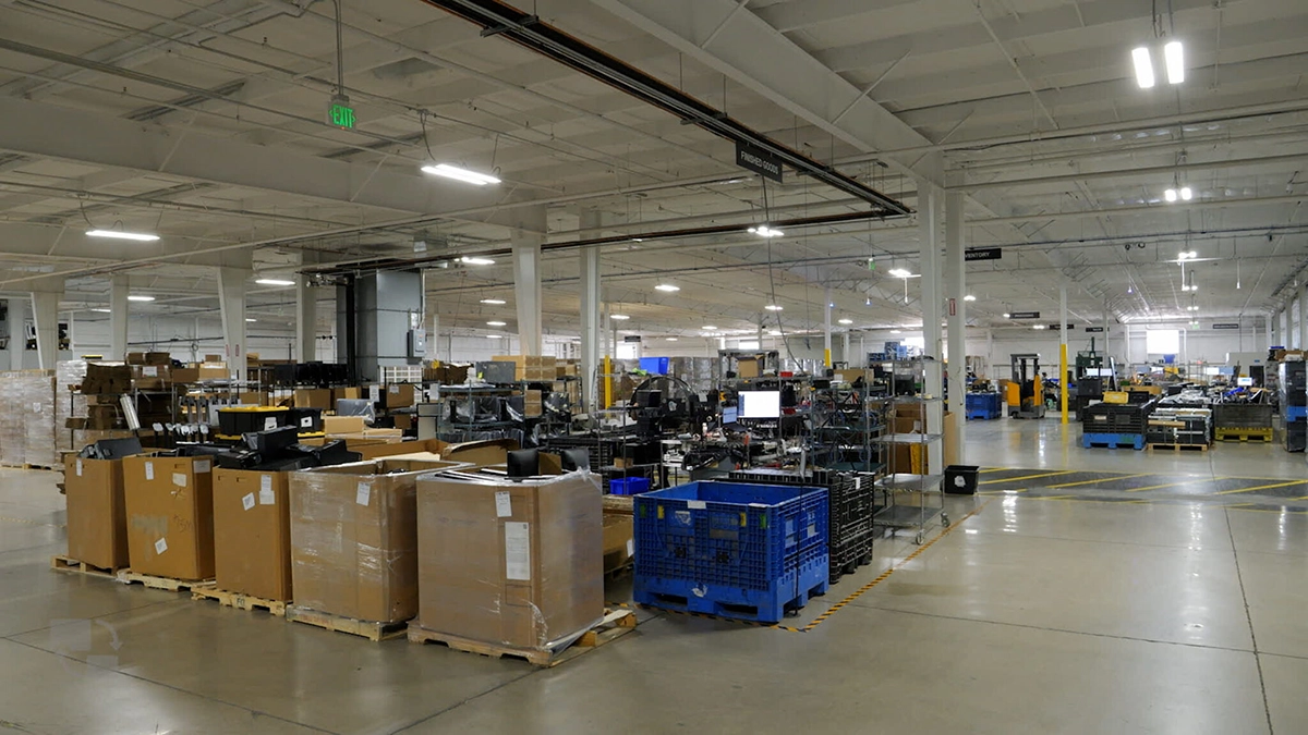 Large reverse logistics warehouse with bins holding returned electronics items