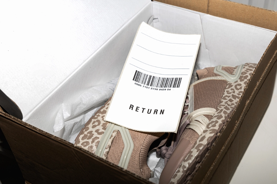 Pair of shoes in a shoe box with a return label for ecommerce returns management