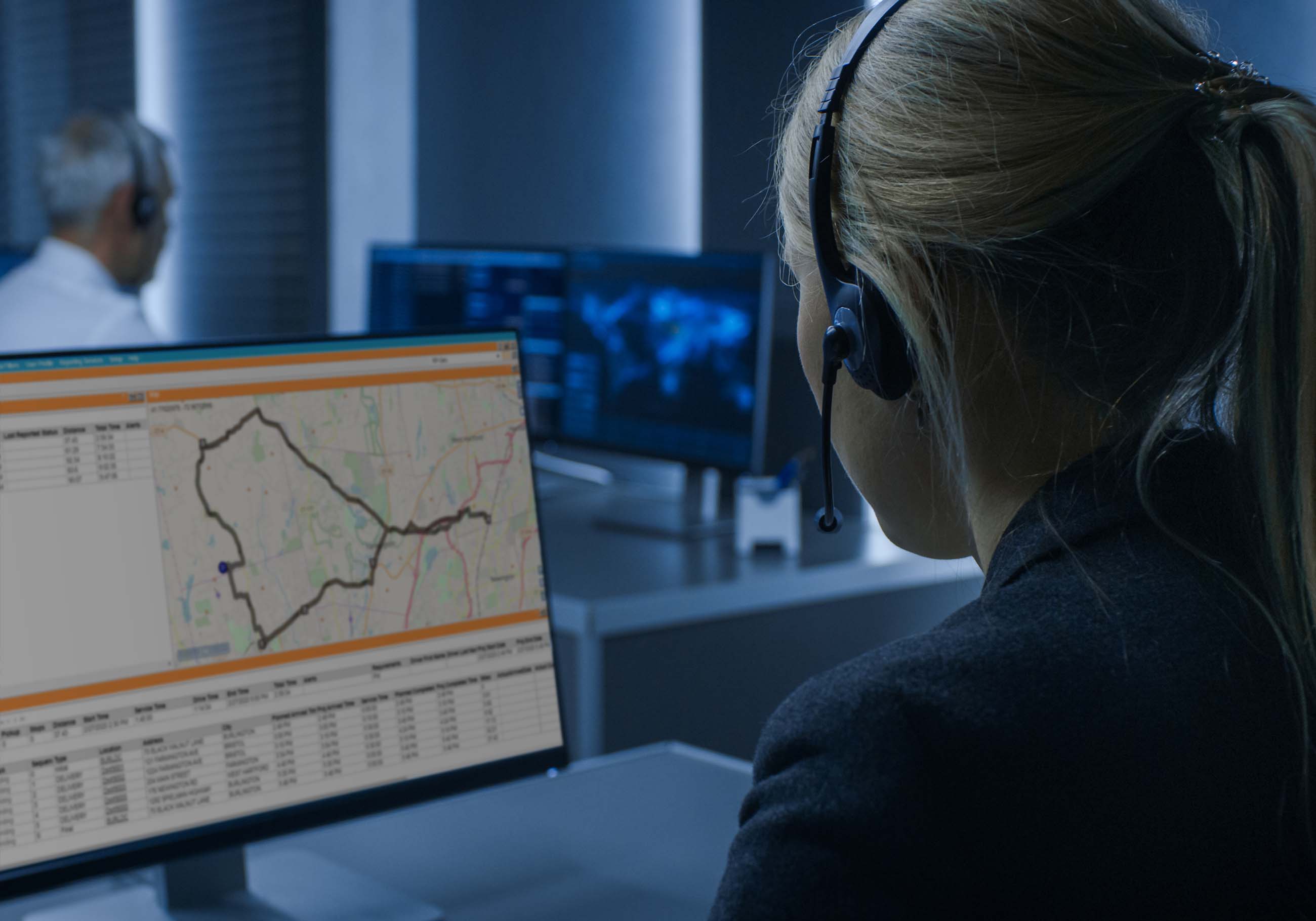 Female route planner looks at route on desktop screen
