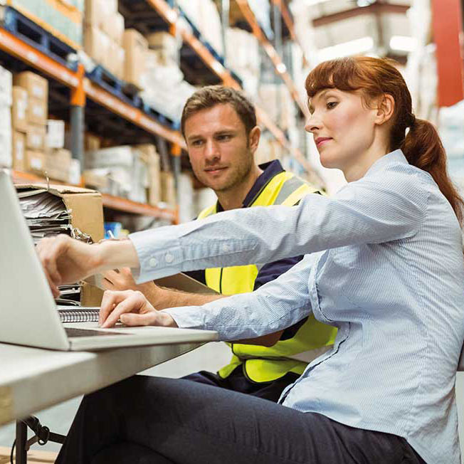 warehouse man woman and computer
