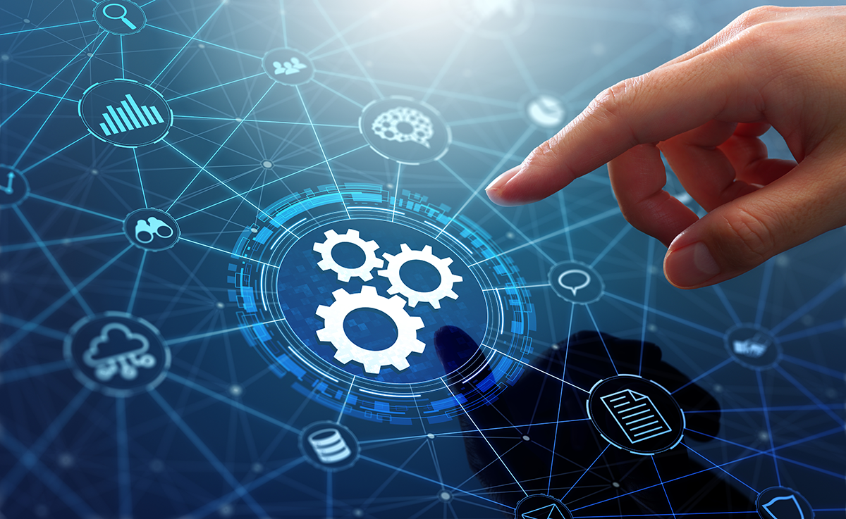 A person’s hand reaches toward an icon of a gear wheel connected to a network of other icons representing integrated ecommerce operations software.