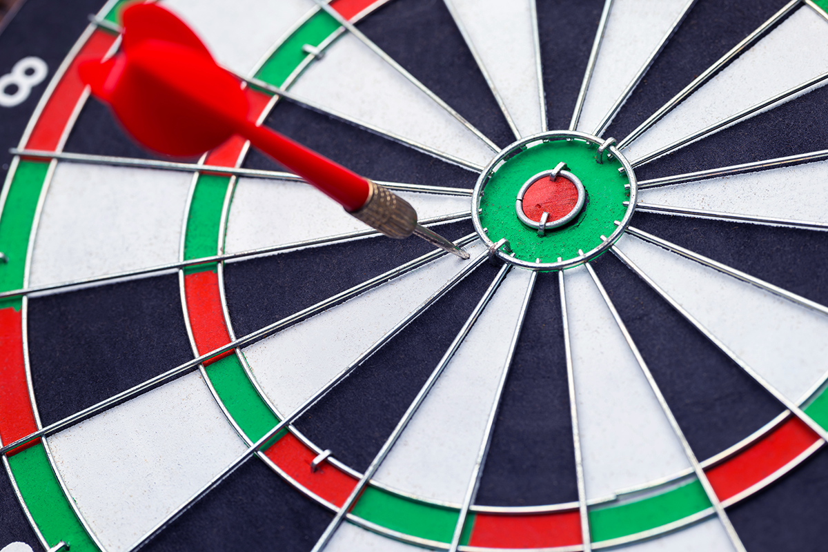 A target with an off-center dart that missed the mark represents strategic misalignment in business.