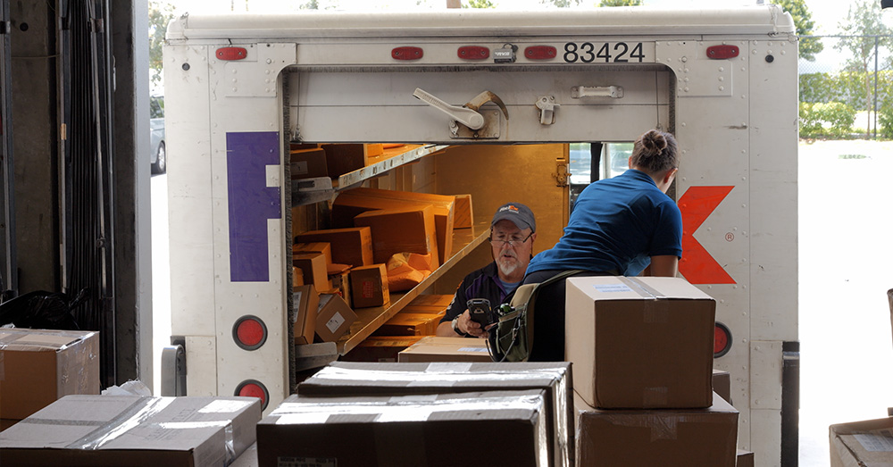 An image showing an ecommerce business loading orders into a FedEx truck.