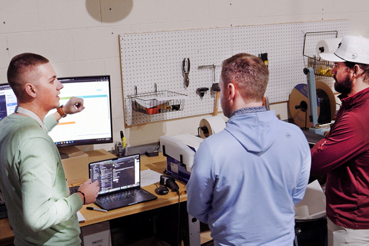 Warehouse workers viewing Descartes Sellercloud dashboards for data analytics
