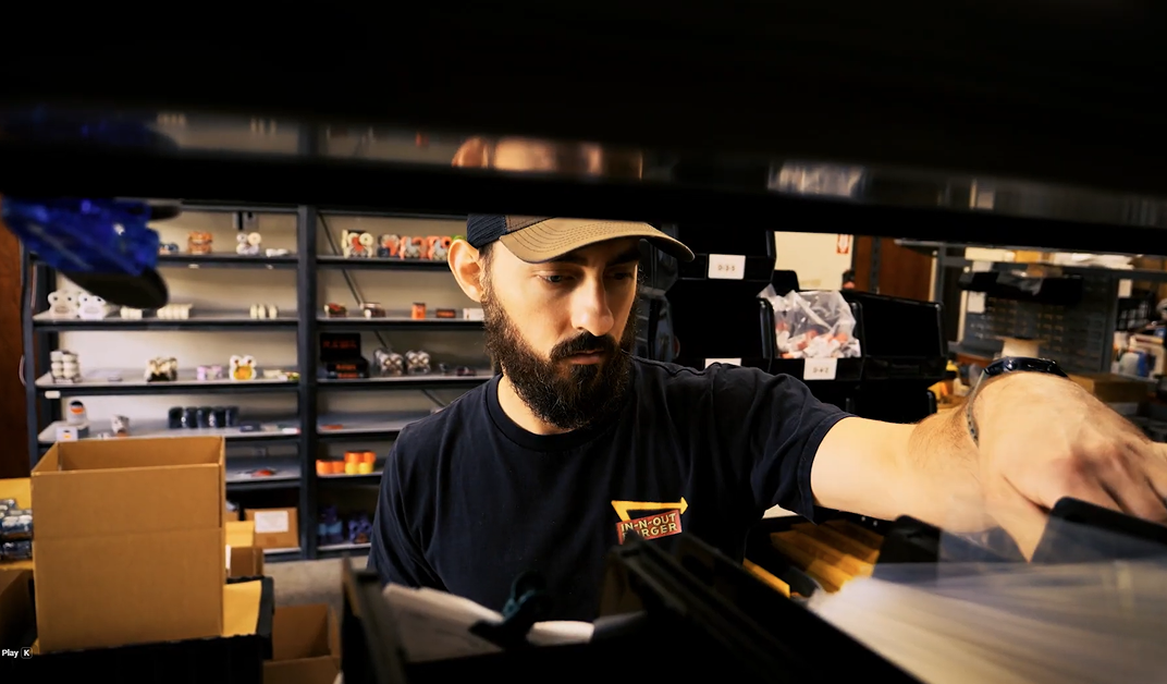 Owner David Rajewski selecting parts from shelving in the Stoked Ride Shop warehouse.