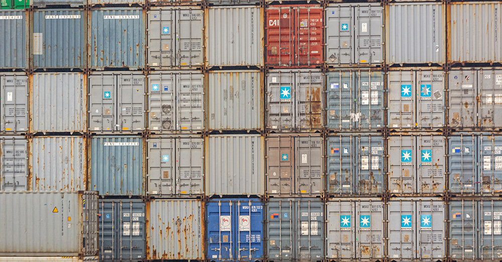 An image showing neatly stacked shipping containers.