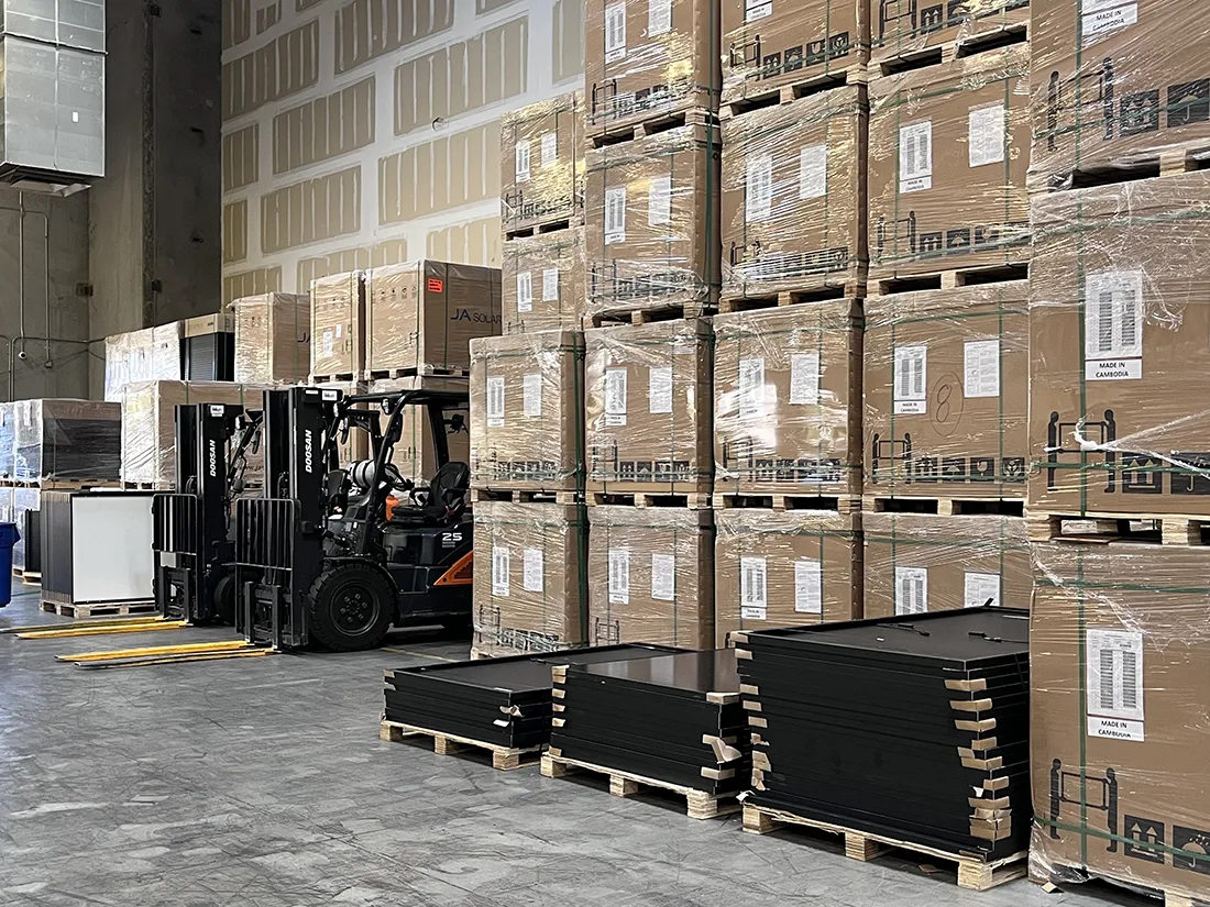 Pallets of products stacked in a warehouse with a forklift