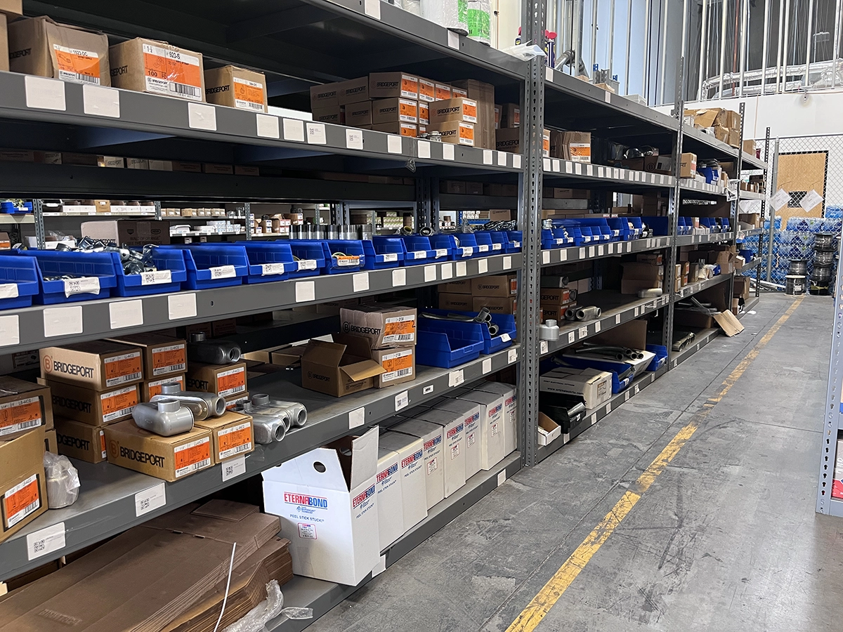 Warehouse shelves with products in open-faced boxes to facilitate quick picking workflows