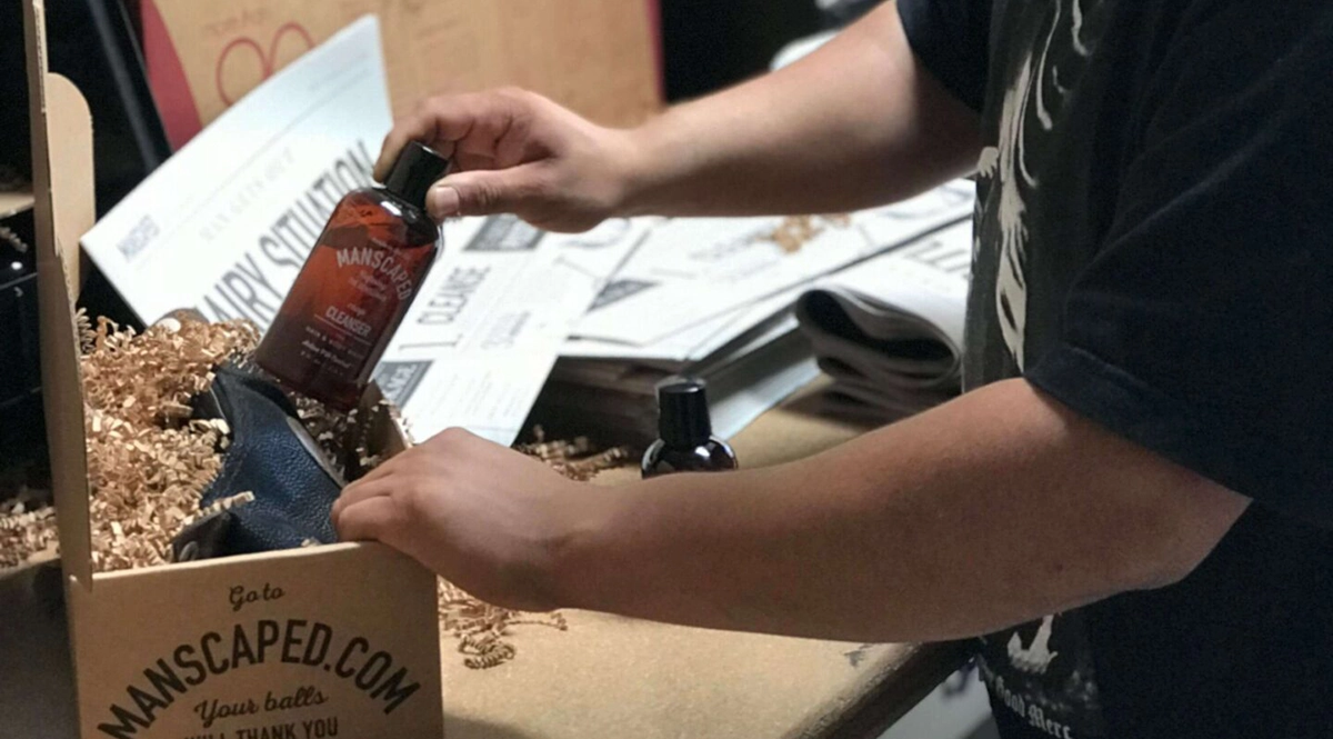 A warehouse worker from the ecommerce brand Manscaped prepares an order for shipment