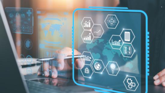 Businessperson on laptop with superimposed technology graphics 