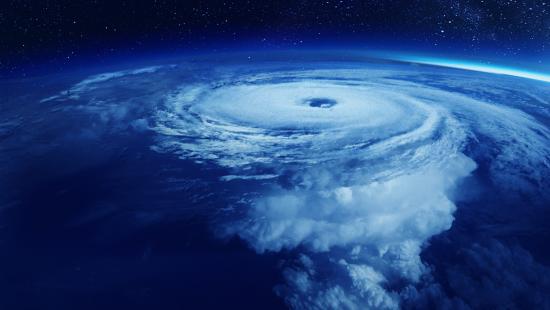 world image with large hurricane clouds representing macroeconomic problems