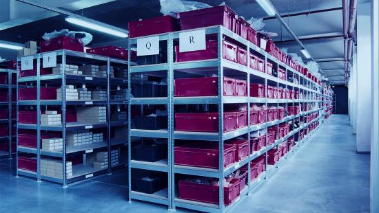 Warehouse Shelves with Red Bins for Warehouse Management System