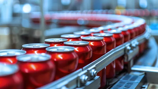 Red soda cans on a manufacturing line