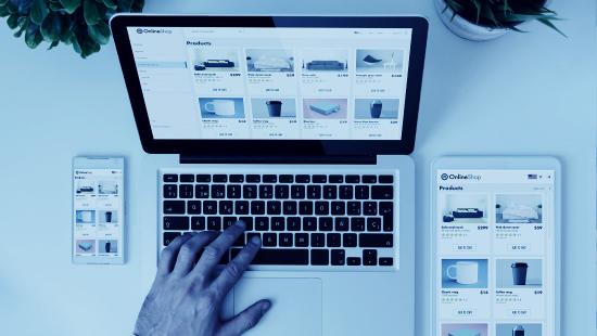 An ecommerce business owner viewing a computer screen containing an online product catalog and listings