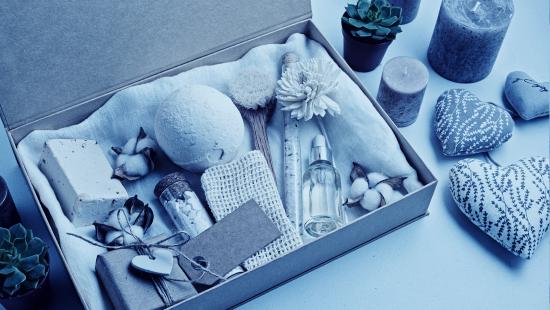 A box full of various spa and personal care items representing kitting products to boost ecommerce sales