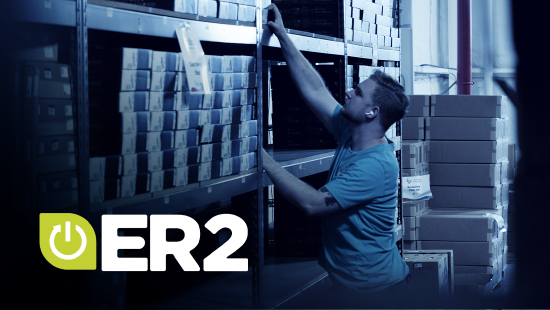 Warehouse employee reaching for boxed inventory on shelving units in a distribution center, with ER2 logo overlay.