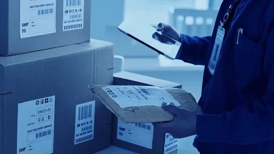 Warehouse worker preparing parcels for shipping