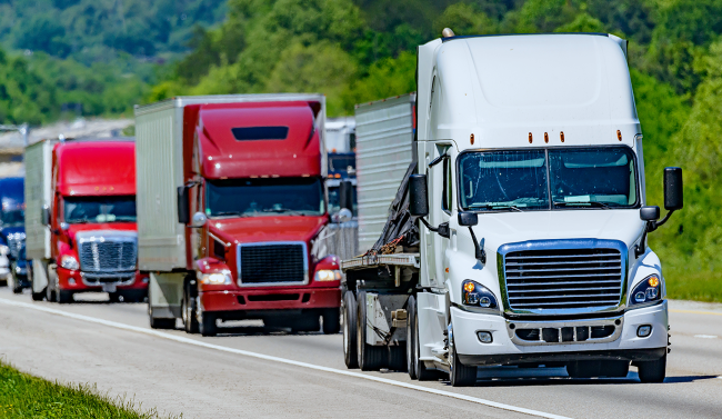 Line of trucks driving on a road
