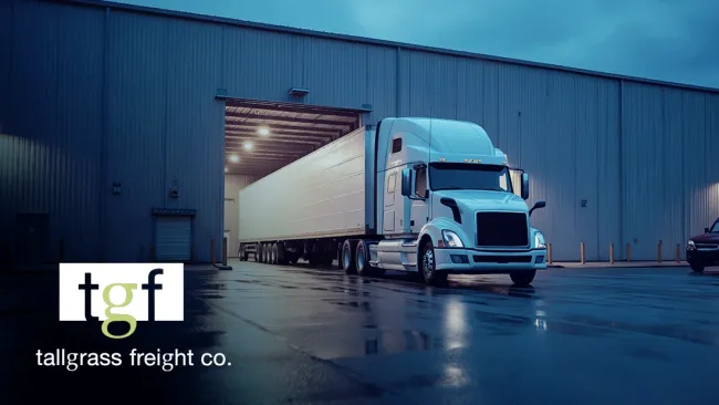 Image of a truck sitting in a loading bay. The Tallgrass Freight logo is displayed in the lower left.